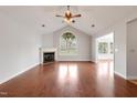 Bright living room boasts a fireplace, hardwood floors, and arched window at 425 Faith Dr, Gibsonville, NC 27249
