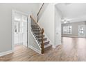 Inviting entryway featuring a staircase, hardwood floors, and access to a powder room at 44 Good Morning Ln, Garner, NC 27529