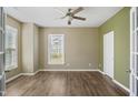 Spacious bedroom with ample natural light, ceiling fan, and neutral paint colors at 5910 Giddings St, Raleigh, NC 27616
