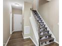 Inviting foyer featuring wood floors, a white front door, and decorative stair risers at 5910 Giddings St, Raleigh, NC 27616