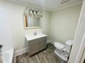 Bathroom with a vanity, mirror, updated lighting, and a toilet at 602 Dexter St, Rocky Mount, NC 27803