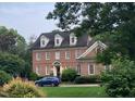 Charming two-story brick home with symmetrical windows and lush landscaping offering excellent curb appeal at 605 Lake Boone Trl, Raleigh, NC 27607