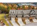 Aerial view of well-maintained townhomes surrounded by mature trees in a desirable community at 635 Grace Hodge Dr, Cary, NC 27519