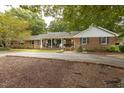 Lovely single-story brick home with a covered front porch and circular driveway at 6517 Whitted Rd, Fuquay Varina, NC 27526