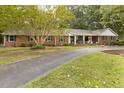 Beautiful brick home featuring a covered front porch and a spacious circular driveway at 6517 Whitted Rd, Fuquay Varina, NC 27526