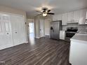Open-concept kitchen featuring white cabinets, stainless steel refrigerator, and seamless flow to other living areas at 803 Flat Rock Church Rd, Louisburg, NC 27549