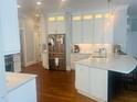 Bright kitchen features white cabinets, stainless steel appliances, granite countertops, and an island at 8729 Valentine Ct, Raleigh, NC 27613