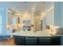 Bright kitchen features white cabinets, stainless steel appliances, granite countertops, and an island at 8729 Valentine Ct, Raleigh, NC 27613