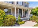 Inviting front porch with white railings, stone columns, and well-maintained landscaping at 947 Middle Ground Ave, Rolesville, NC 27571