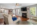 Cozy living room with a fireplace, hardwood floors, and large windows that bring in natural light at 947 Middle Ground Ave, Rolesville, NC 27571