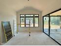 Bright living room with large windows and sliding doors, with construction materials on the floor at 10 Gambel Dr, Youngsville, NC 27596