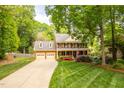 Charming two-story brick home with a manicured lawn, colorful flowerbeds and a two-car garage at 102 Pin Oak Ct, Elon, NC 27244