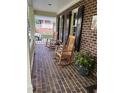 Inviting front porch with rocking chairs, perfect for relaxing and enjoying the outdoors at 102 Pin Oak Ct, Elon, NC 27244