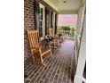 Inviting front porch with rocking chairs, perfect for relaxing and enjoying the outdoors at 102 Pin Oak Ct, Elon, NC 27244