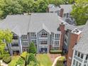 An aerial view of the condominiums featuring a lovely courtyard with manicured lawns and lush landscaping at 1061 Wirewood Dr # 303, Raleigh, NC 27605