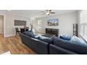 Spacious living room featuring a comfortable blue sectional, hardwood floors, and a staircase, perfect for relaxation and entertaining at 107 York Dr, Oxford, NC 27565