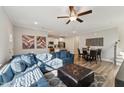 Bright and airy living room featuring a comfortable blue sectional and modern decor, adjacent to the kitchen and dining area at 107 York Dr, Oxford, NC 27565