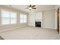 Cozy living room featuring a fireplace, built-in bookshelves, and carpet floors providing a comfortable living space at 123 Pleasant View Ln, Benson, NC 27504