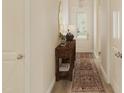Cozy entryway with wooden console table, decorative mirror, and patterned rug at 139 W Crescent Mills Blvd # Homesite 235, Wilson's Mills, NC 27520