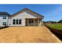 New construction home with porch and large windows in a suburban neighborhood at 139 W Crescent Mills Blvd # Homesite 235, Wilson's Mills, NC 27520