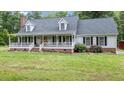 Beautiful home featuring a large covered front porch and well-maintained landscaping at 1401 Berea Rd, Rougemont, NC 27572