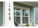 Close-up of the house number and decorative statue by the shuttered window at 1448 Big Falls Dr, Wendell, NC 27591