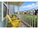 Cozy front porch view with bright yellow Adirondack chairs and neighborhood view at 1448 Big Falls Dr, Wendell, NC 27591