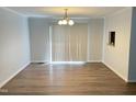 Dining room featuring hardwood floors, a chandelier, and natural light at 145 Country Walk Ln, Sanford, NC 27332