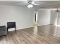 Spacious living room with wood floors, neutral paint, lots of natural light, and modern ceiling fan at 145 Country Walk Ln, Sanford, NC 27332