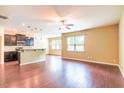 Open-concept living room with hardwood floors, recessed lighting, and a view of the kitchen at 145 Torrey Heights Ln, Durham, NC 27703