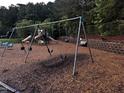 Community playground featuring swings, slides, and climbing structures set in a bark mulch area at 1527 Haywards Heath Ln, Apex, NC 27502