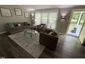 Inviting living room featuring ample natural light, stylish furnishings, and a welcoming atmosphere at 195 Windsong Ln, Youngsville, NC 27596