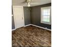 Cozy bedroom featuring hardwood-style floors, natural light from window, and ceiling fan at 207 2Nd St, Erwin, NC 28339