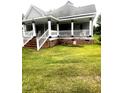 Home features a front porch with classic railings, brick base and a well-maintained lawn at 2113 Lee, Sanford, NC 27330