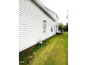 The side of the home features the exterior and the well-maintained lawn at 2113 Lee, Sanford, NC 27330