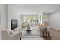 Bright living room boasts a fireplace, large windows and hardwood floors, creating a welcoming space at 216 Burkwood Ln, Raleigh, NC 27609