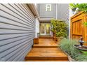 View of the wooden deck entryway with a decorative trellis and access to the home's entrance at 2205 Landings Way, Raleigh, NC 27615