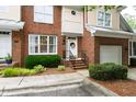 Inviting townhouse showcases a brick facade, manicured landscaping, and cozy front entrance at 222 Ashton Hall Ln, Raleigh, NC 27609