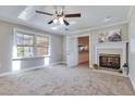 Bright living room with a fireplace, skylights, and a ceiling fan at 3009 Wellington Dr, Rocky Mount, NC 27803