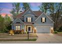 Inviting two-story home with a well-lit exterior, manicured lawn, and a cozy front porch at 347 Country Mill Way, Fuquay Varina, NC 27526