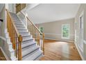 Bright foyer featuring hardwood floors, a staircase, and ample natural light at 3511 Shady Creek Dr, Durham, NC 27713