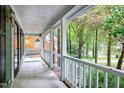 Cozy porch with white railings and a swing overlooking the lush greenery at 3511 Shady Creek Dr, Durham, NC 27713