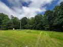 Expansive green lawn with lush trees, ideal for recreation and relaxation at 4040 Tyler Dr, Oxford, NC 27565