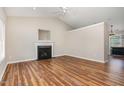 Spacious living room with wood floors, featuring a classic fireplace and an open layout for entertaining at 5437 Advantis Dr, Raleigh, NC 27610