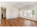 Bright living room featuring beautiful wood floors, vaulted ceiling, and a large window for natural light at 5437 Advantis Dr, Raleigh, NC 27610