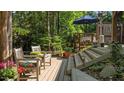 Cozy wooden deck with comfortable seating, offering a tranquil outdoor retreat surrounded by lush greenery at 648 Long Melford Dr, Rolesville, NC 27571