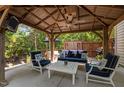 Inviting covered patio with comfortable seating, a ceiling fan, and an outdoor television for entertainment at 648 Long Melford Dr, Rolesville, NC 27571