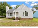Cozy home features a classic design, lovely front lawn, and inviting entryway steps at 71 E Boxley Dr, Wendell, NC 27591