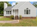 Attractive single-Gathering home featuring gray siding, classic windows and an inviting brick-lined entrance at 71 E Boxley Dr, Wendell, NC 27591