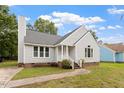 Quaint gray house with a brick foundation, inviting front porch, and a neatly maintained lawn at 71 E Boxley Dr, Wendell, NC 27591